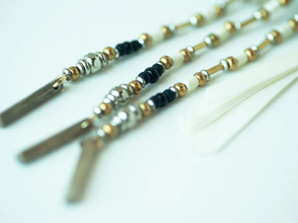 Close-up of beaded silver and gold boho necklace strands