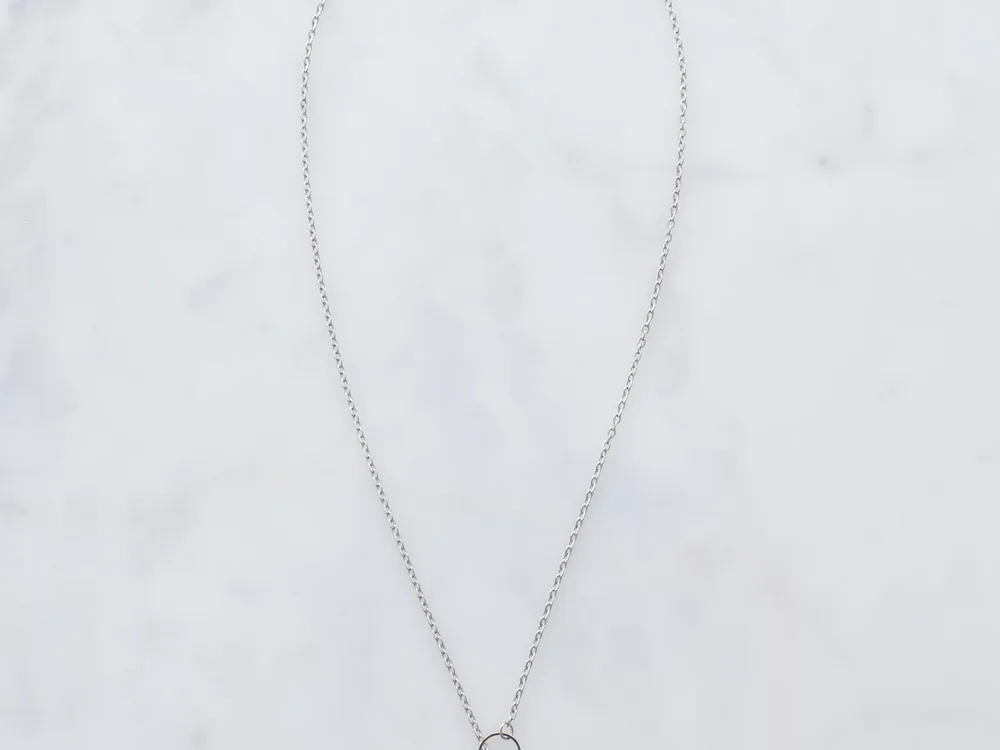 Minimal custom silver threader necklace sample on marble