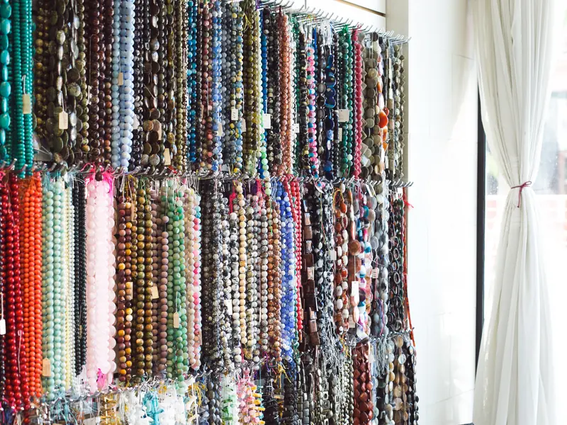 Wall of gemstone bead strands for Bali mala necklaces
